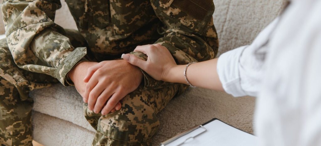 A military Doctor consoleing a soldier.