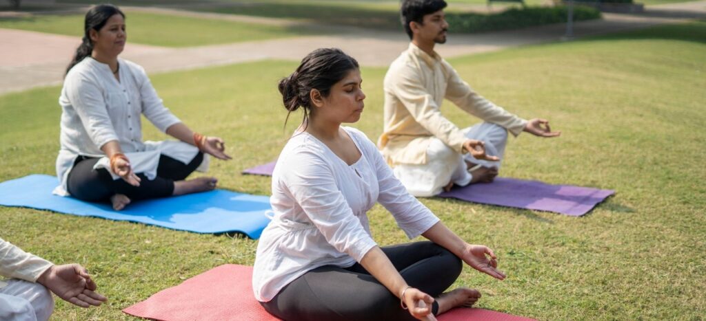 A group of people practising yoga for wellness and positivity.
