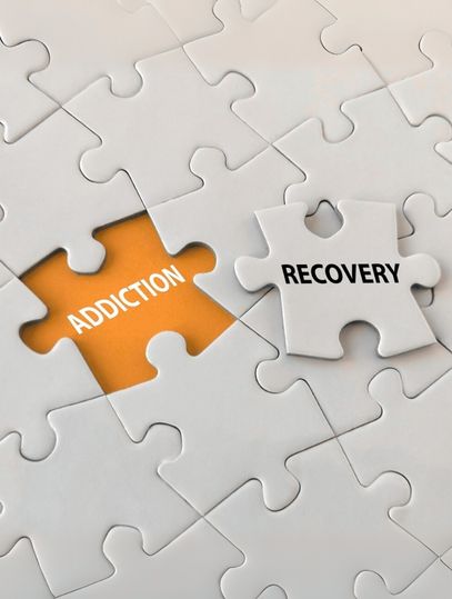 Puzzle blocks labelled addiction and recovery
